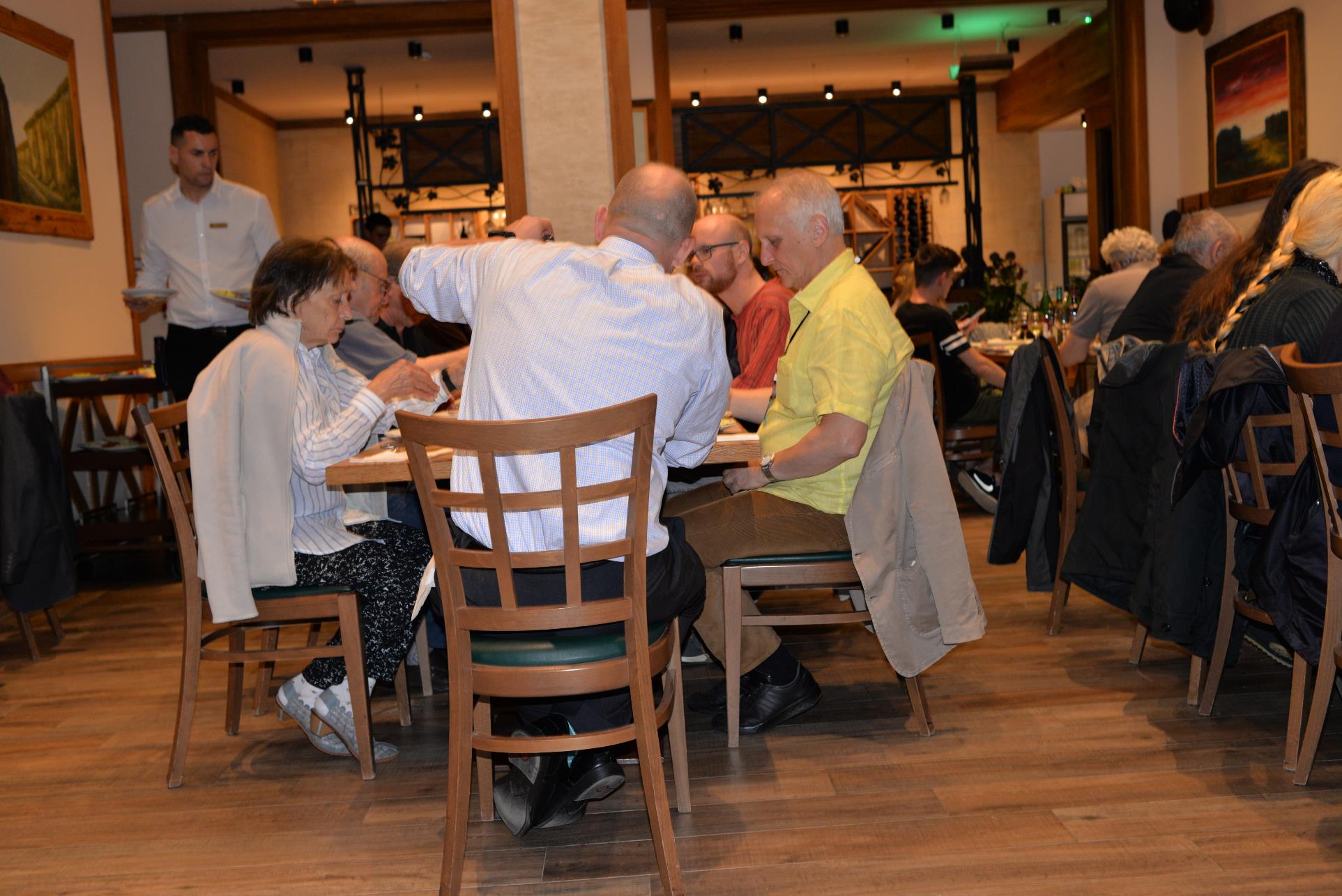 A group of people sitting at a table

Description automatically generated