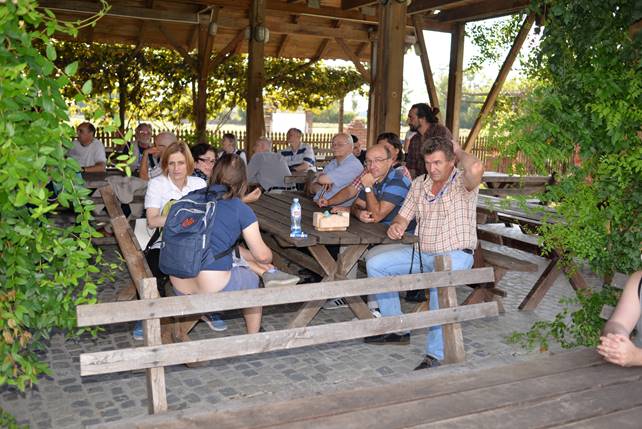 A group of people sitting at a picnic table

Description generated with very high confidence