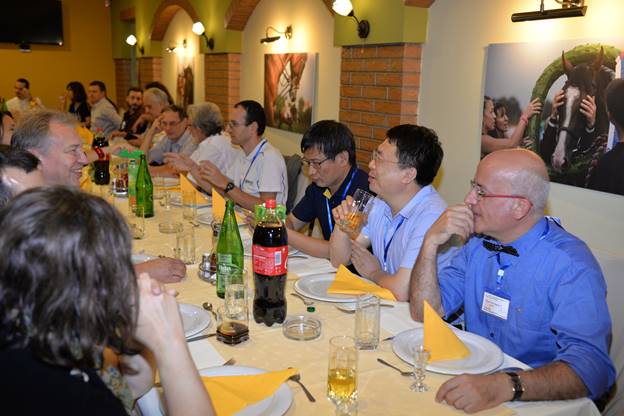 A group of people sitting at a table with wine glasses

Description generated with very high confidence