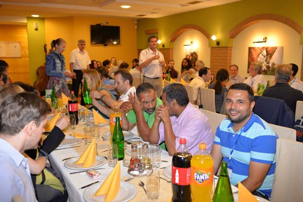 A group of people sitting at a table with wine glasses

Description generated with very high confidence