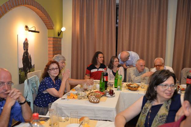 A group of people sitting at a dinner table

Description generated with very high confidence