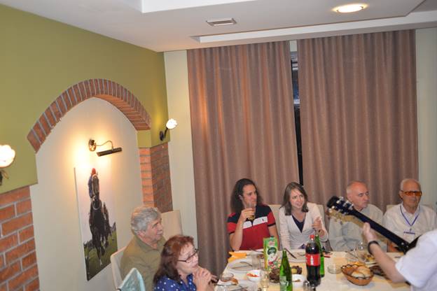 A group of people sitting at a table

Description generated with very high confidence