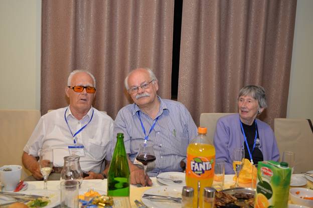 A group of people sitting at a table with wine glasses

Description generated with very high confidence