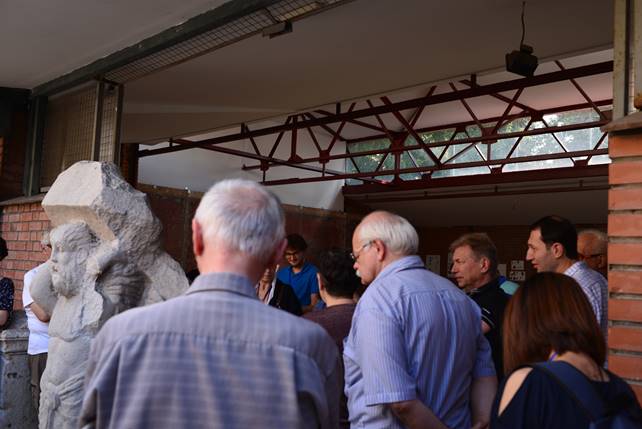 A group of people standing in front of a crowd

Description generated with very high confidence