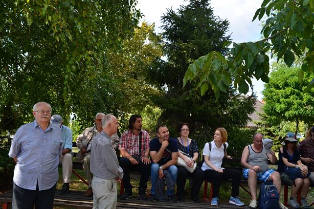 A group of people standing next to a tree

Description generated with very high confidence