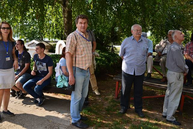 A group of people standing next to a tree

Description generated with very high confidence