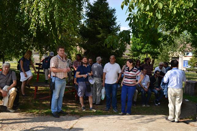 A group of people standing next to a tree

Description generated with very high confidence