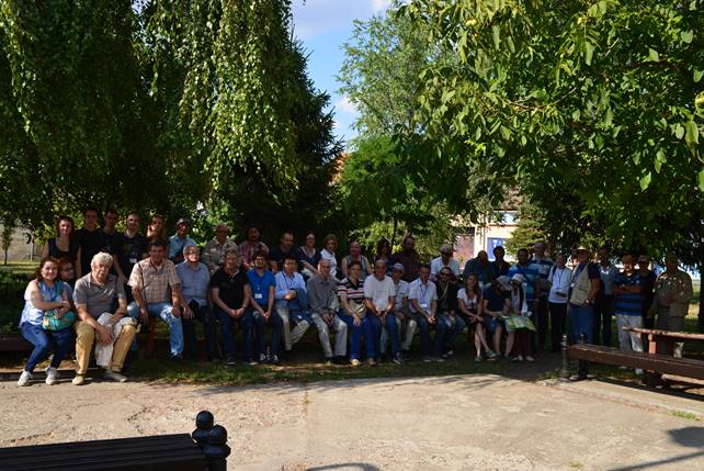 A group of people standing in front of a tree

Description generated with very high confidence