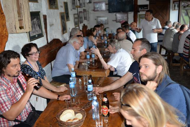 A group of people sitting at a table in a restaurant

Description generated with very high confidence