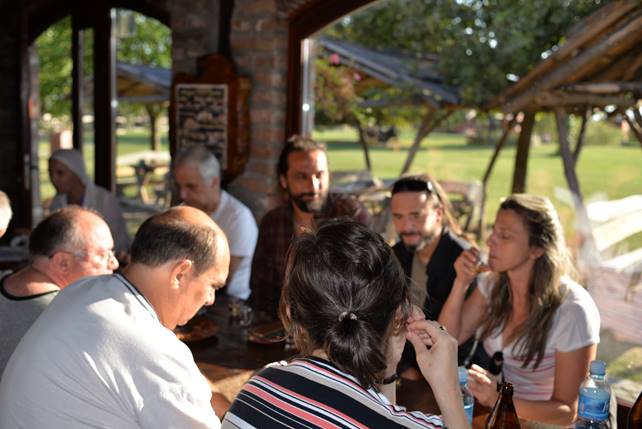 A group of people sitting at a table with wine glasses

Description generated with very high confidence