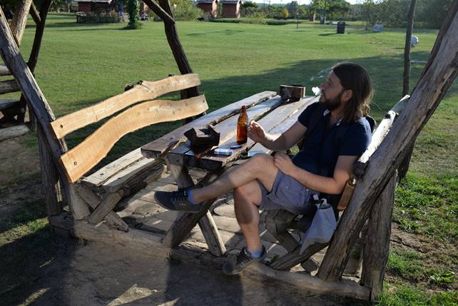 A person sitting on a bench in a park

Description generated with high confidence