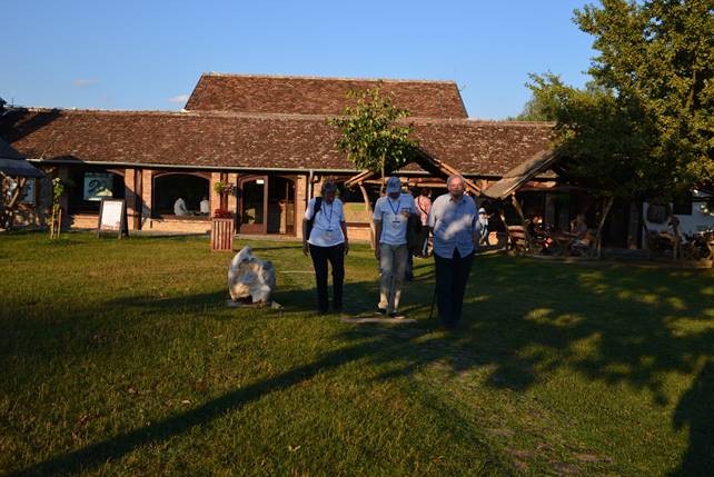 A group of people standing in front of a house

Description generated with very high confidence