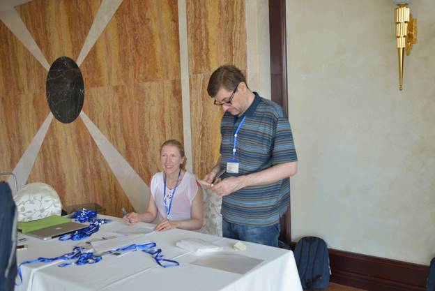 Two people sitting at a table

Description generated with high confidence