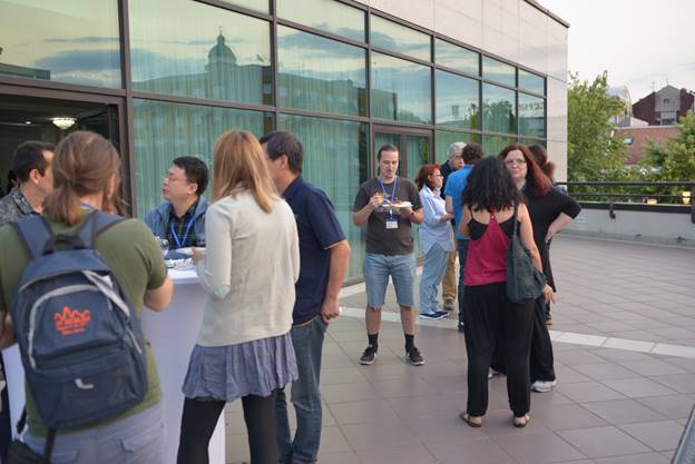 A group of people standing in front of a building

Description generated with very high confidence