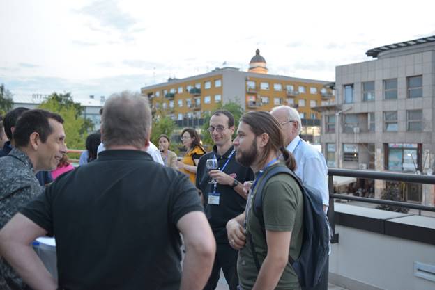 A group of people standing in front of a building

Description generated with very high confidence