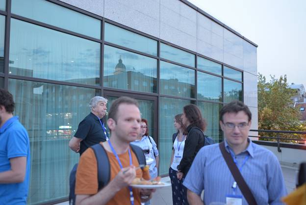 A group of people standing in front of a building

Description generated with very high confidence