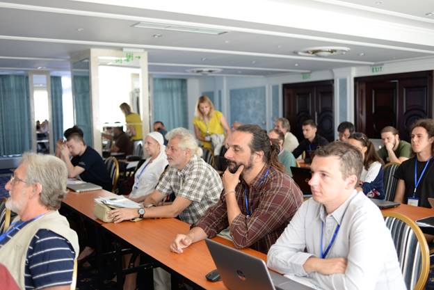 A group of people sitting at a table

Description generated with very high confidence