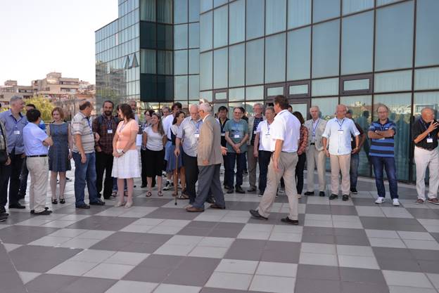 A group of people standing in front of a building

Description generated with very high confidence