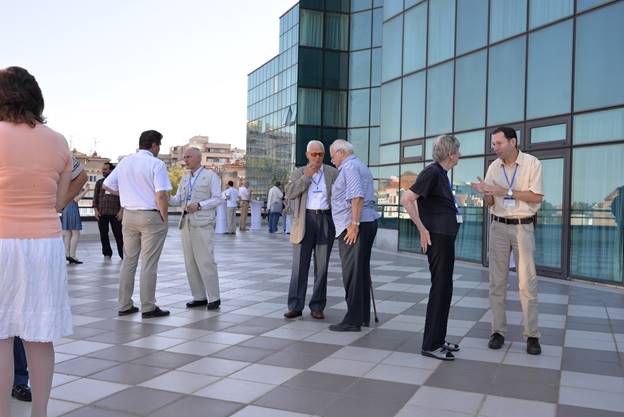 A group of people standing in front of a building

Description generated with very high confidence