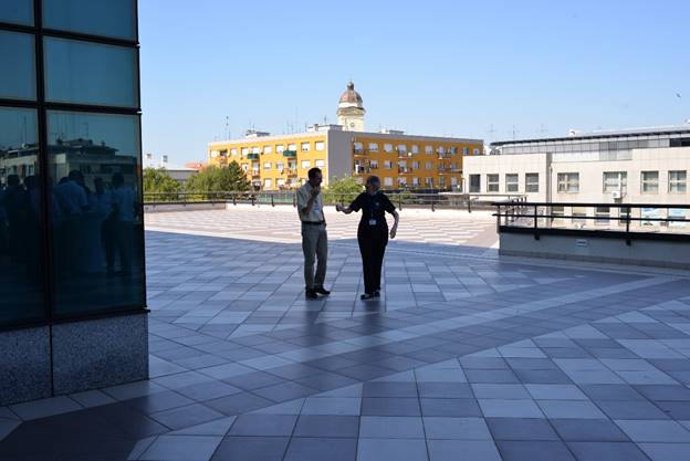 A person standing in front of a building

Description generated with very high confidence