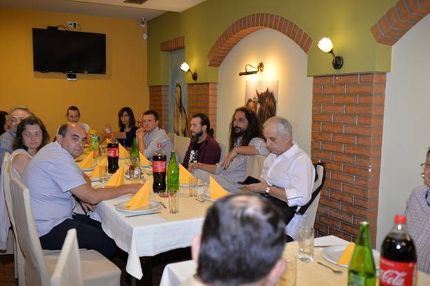 A group of people sitting at a table with wine glasses

Description generated with very high confidence