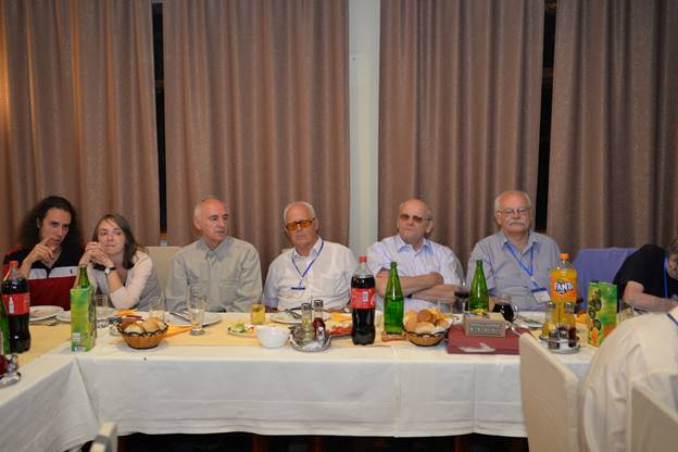 A group of people sitting at a table with wine glasses

Description generated with very high confidence