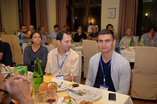 A group of people sitting at a dinner table

Description generated with very high confidence