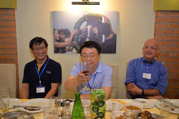 A group of people sitting at a table eating food

Description generated with very high confidence