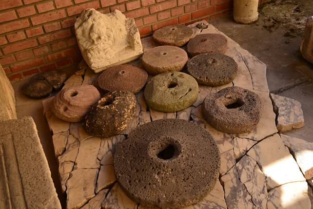 A close up of a doughnut sitting next to a stone wall

Description generated with high confidence