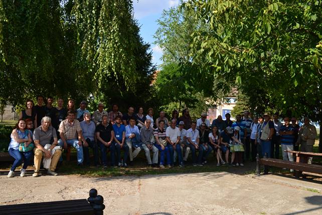 A group of people standing next to a tree

Description generated with very high confidence