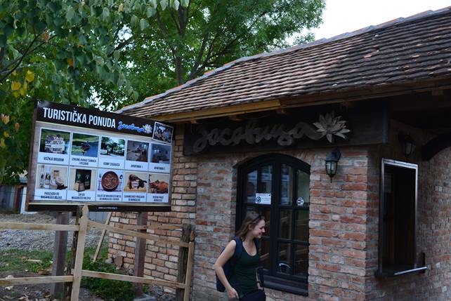 A person standing in front of a brick building

Description generated with very high confidence