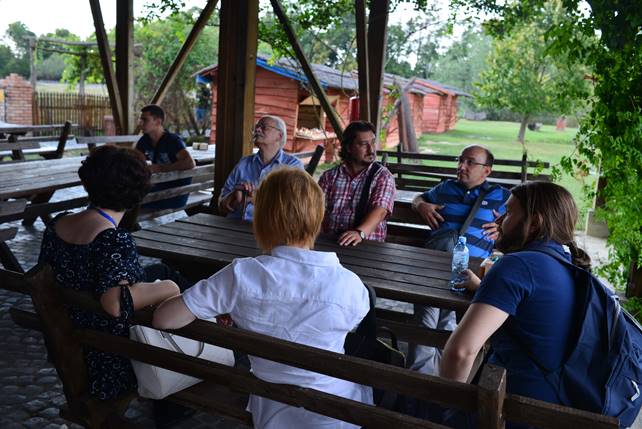 A group of people sitting at a table

Description generated with very high confidence