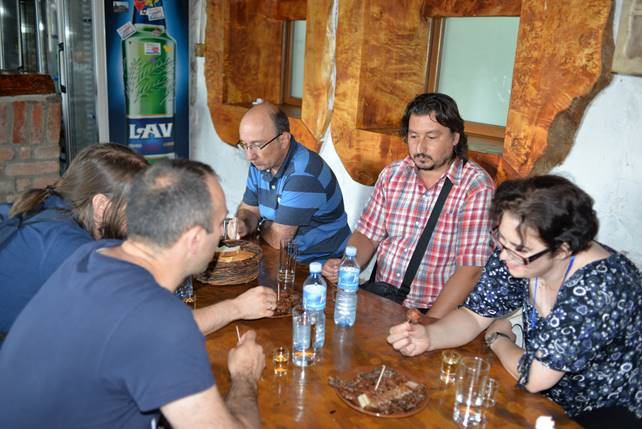 A group of people sitting at a table

Description generated with very high confidence