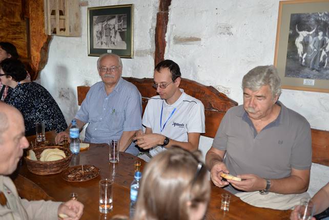 A group of people sitting at a table with wine glasses

Description generated with very high confidence