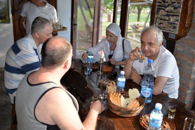 A group of people sitting at a table

Description generated with very high confidence