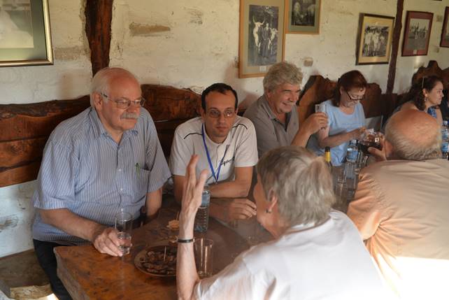 A group of people sitting at a table

Description generated with very high confidence