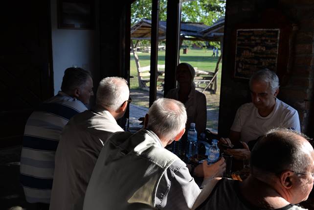 A group of people sitting at a table

Description generated with very high confidence