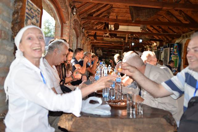 A group of people sitting at a table with wine glasses

Description generated with very high confidence