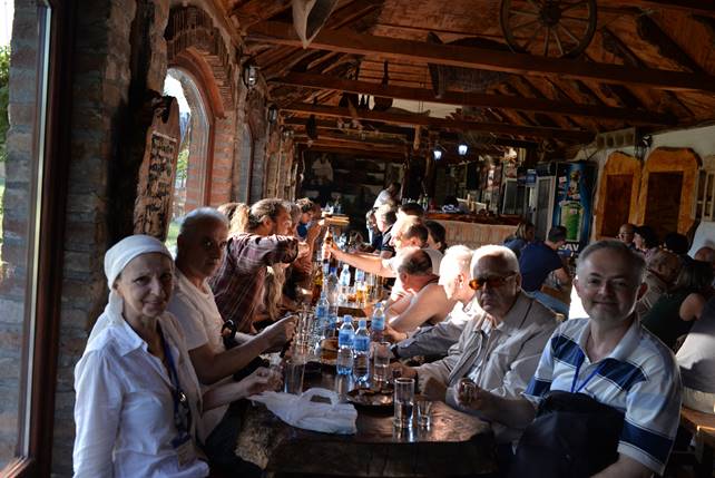 A group of people sitting at a table in a restaurant

Description generated with very high confidence