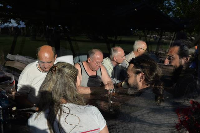 A group of people sitting at a table

Description generated with high confidence