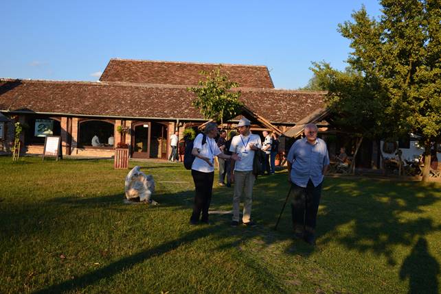 A group of people standing in front of a house

Description generated with very high confidence