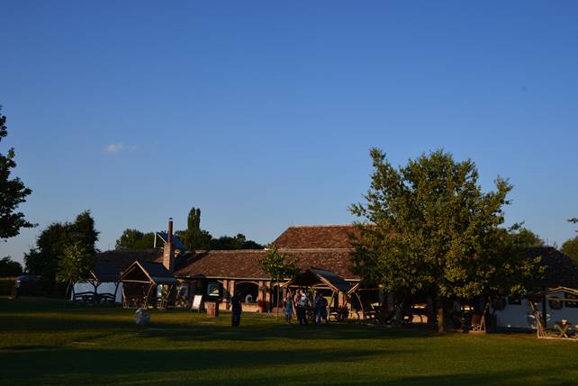 A group of people walking across a grass covered field

Description generated with very high confidence