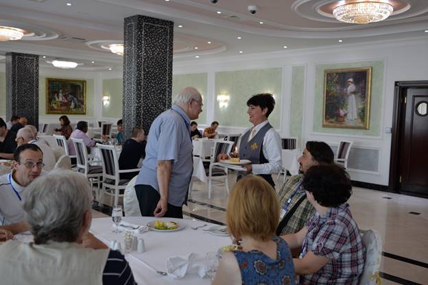 A group of people sitting at a table

Description generated with very high confidence