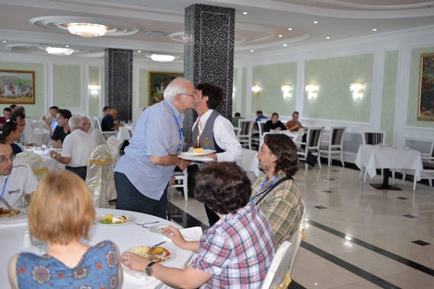 A group of people sitting at a table

Description generated with very high confidence