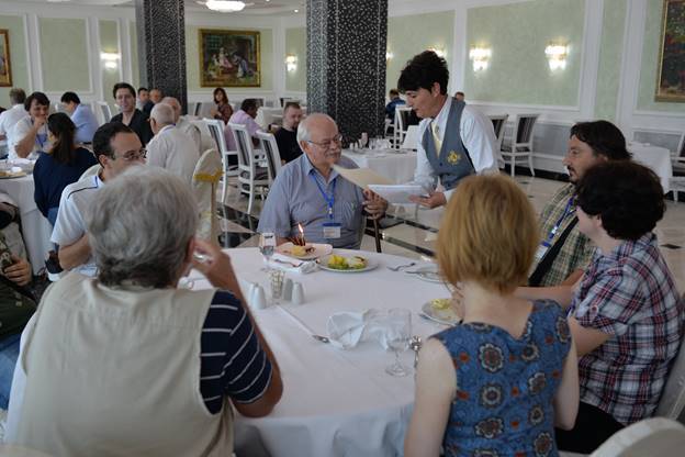 A group of people sitting at a table

Description generated with very high confidence