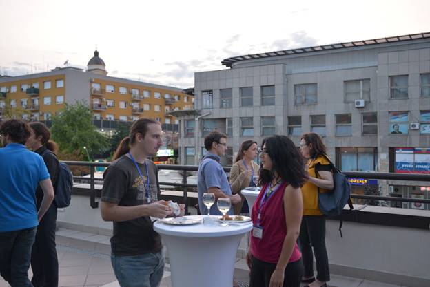 A group of people standing in front of a building

Description generated with very high confidence