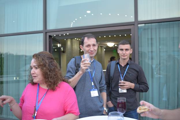 A group of people standing in front of a window

Description generated with very high confidence