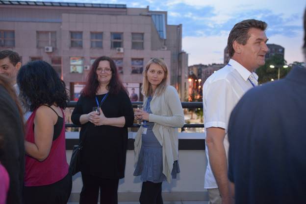 A group of people standing in front of a building

Description generated with very high confidence