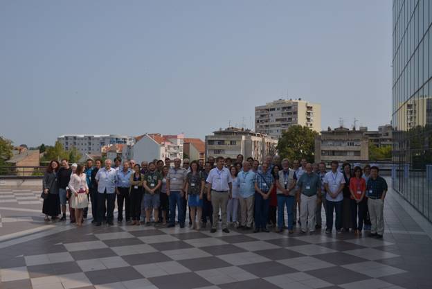 A group of people walking down a street

Description generated with very high confidence