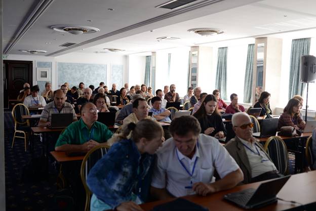 A group of people sitting at a table in front of a crowd

Description generated with very high confidence